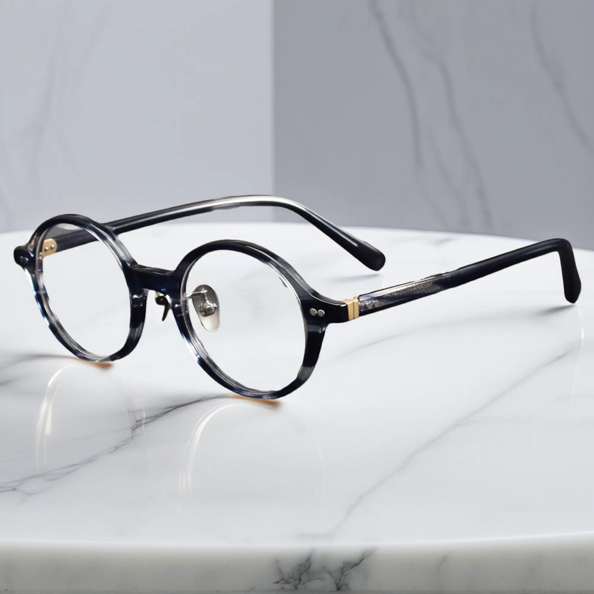 Blue Tortoise round eyeglasses showing titanium nose pads and metal-insert hinges